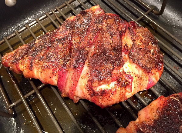 cooked bacon-wrapped chicken on a rack