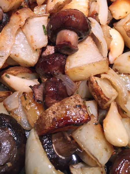 cooked potatoes and mushrooms on the pan