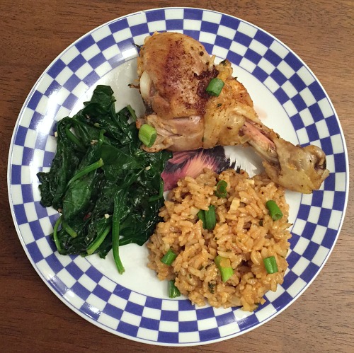 plate of chickendrumsticks, rice, and spinach