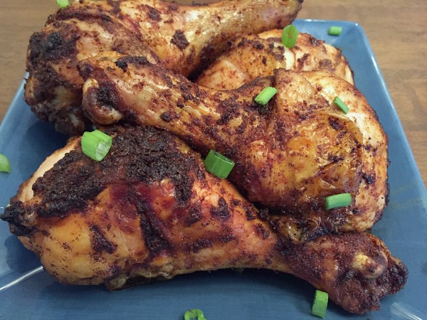 baked dry rub chicken drumsticks on a blue plate