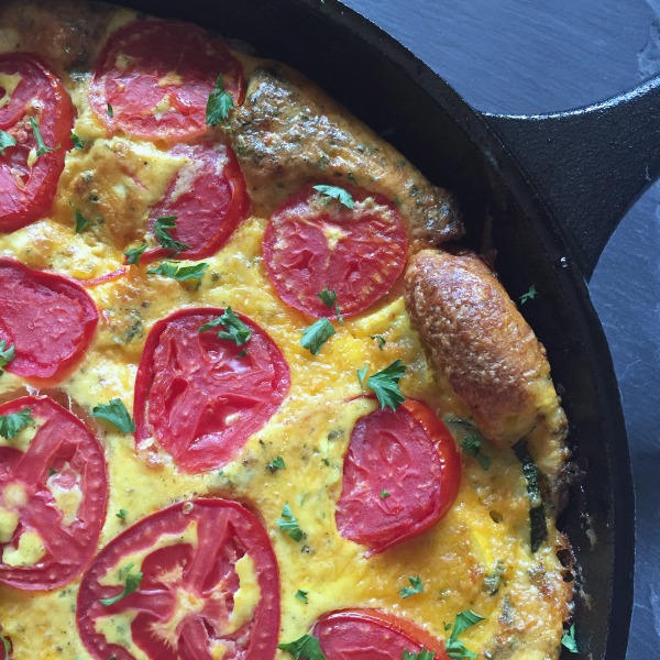 summer squash + tomato frittata in a skillet