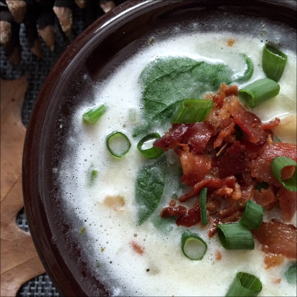 bowl of potato soup with lots of bacon