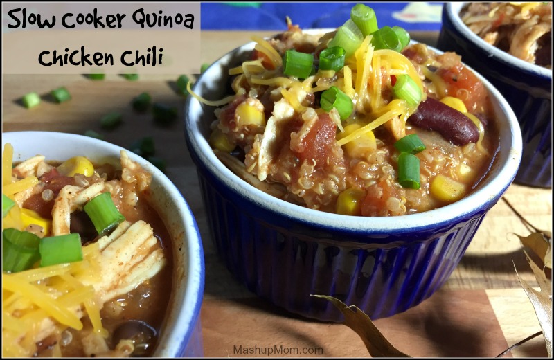 bowls of chicken chili with quinoa, topped with cheese and green onions