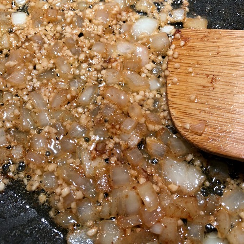 Onions and garlic in pan. This savory "thyme for a one pan chicken mushroom rice skillet" is both filling and naturally gluten free: Browned butter adds an underlying nutty richness, while thyme brings out the umami flavor of the mushrooms. Have a green veggie with this easy one pot recipe (spinach works great) for a simple complete meal. 