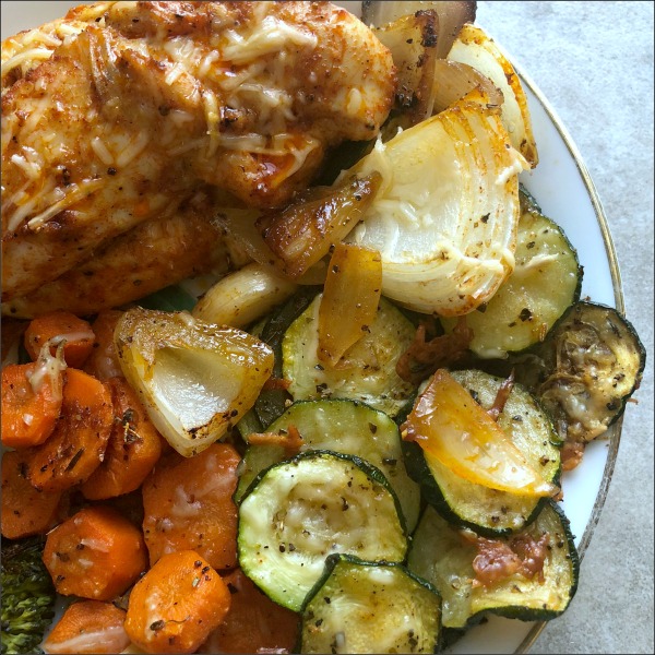 plate of parmesan chicken with parmesan veggie side