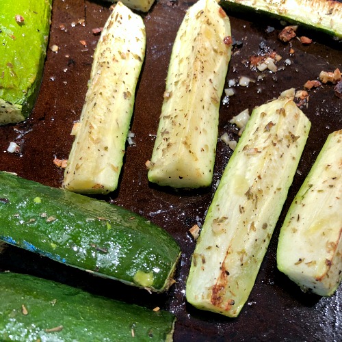 Broiled zucchini on pan -- This flavorful 30 minute pork chops and zucchini recipe creates its own built-in side, making it an affordable weeknight dinner option for four. (The Greek yogurt sauce here really brings out the flavor in both the zucchini and the chops!) Broiled pork chops and zucchini are naturally low carb and gluten free.