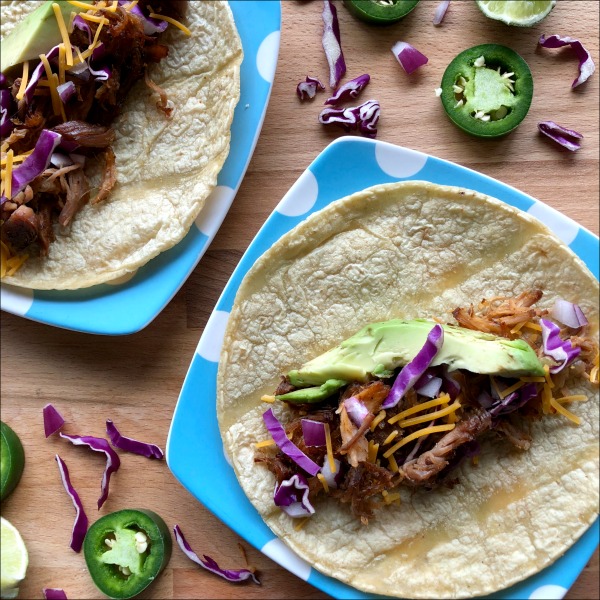 Easy Slow Cooker Pork Carnitas are a great way to make use of one of those big pork roasts that often go on sale. Throw this easy carnitas recipe into your Crock-Pot for up to ten hours before you leave for the day, and it takes just 20 minutes to shred and crisp up when you get home. Naturally gluten free (served on corn tortillas).