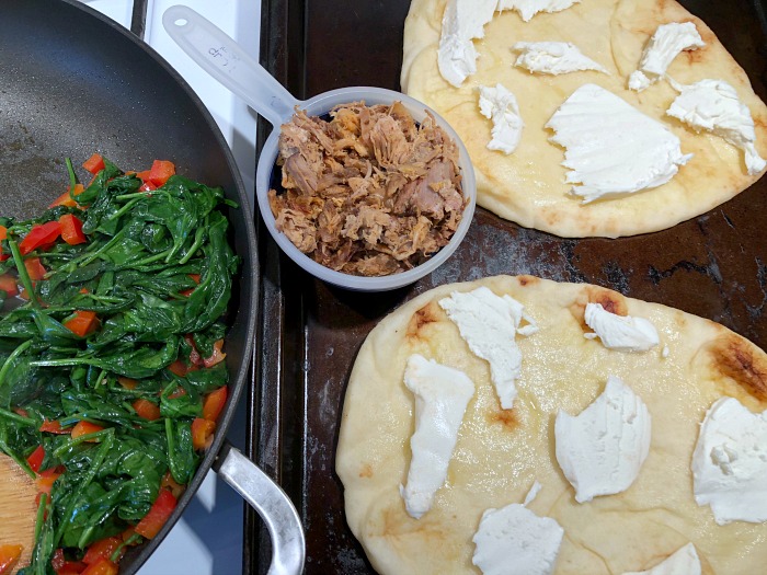 assembling the naan pizzas