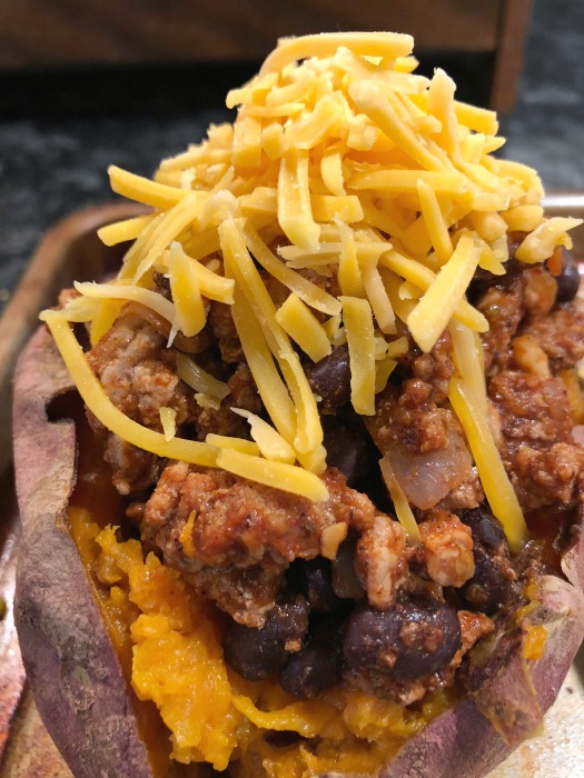 These flavorful turkey taco stuffed sweet potatoes are super easy to make, and naturally gluten free. Give this easy turkey tacos recipe a try on your next Taco Tuesday! Top the turkey taco sweet potatoes with a little shredded cheese + your own favorite taco toppings. 