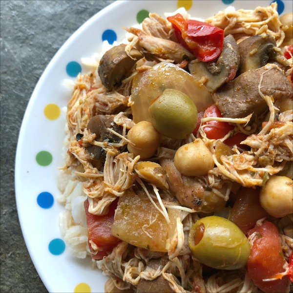 plate of chicken stew with olives and chickpeas