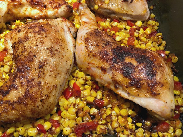 chicken and corn coming out of the oven