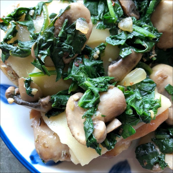 chicken topped with cheese, spinach, and mushrooms