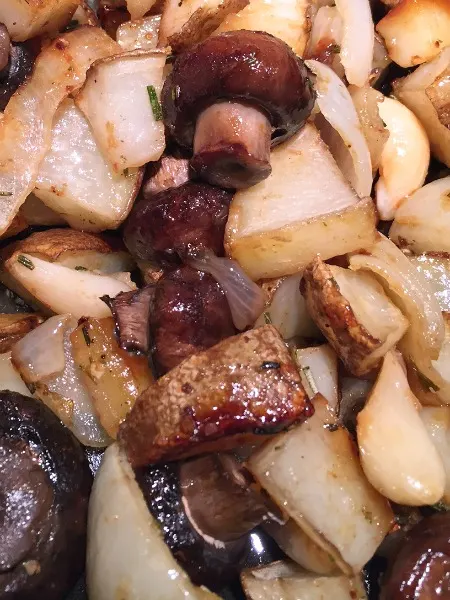 cooked potatoes and mushrooms on the pan