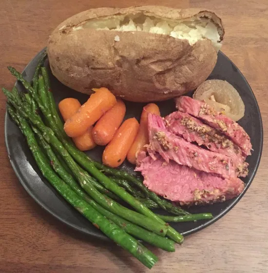 plate of corned beef, carrots, potato, and asparagus
