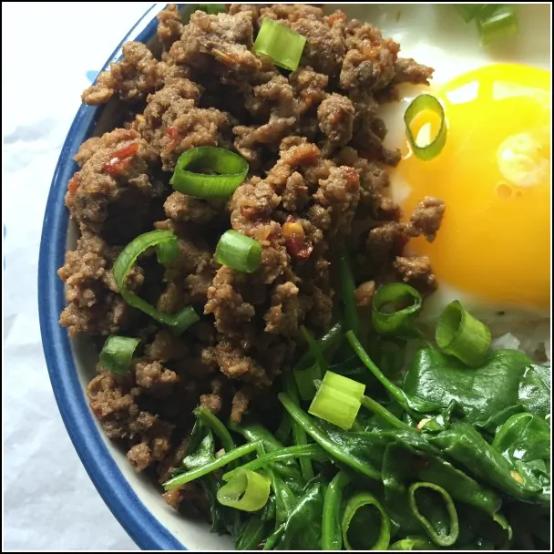 A bowl of Korean style ground beef & spinach with egg