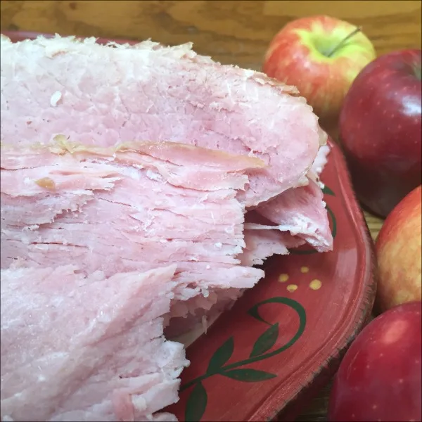 ham on a plate with apples