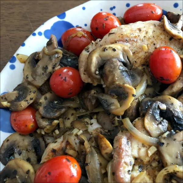 pork chops covered with mushrooms and tomatoes