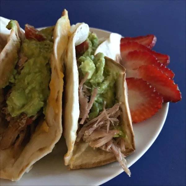 pulled pork tacos on a plate