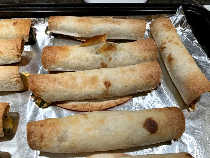 finished taquitos on baking sheet