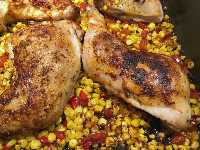 chicken and corn coming out of the oven