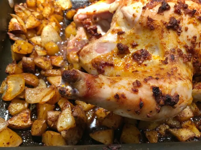 roasted chicken and potatoes in pan