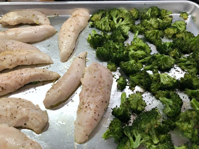 roasted chicken and broccoli on baking sheet