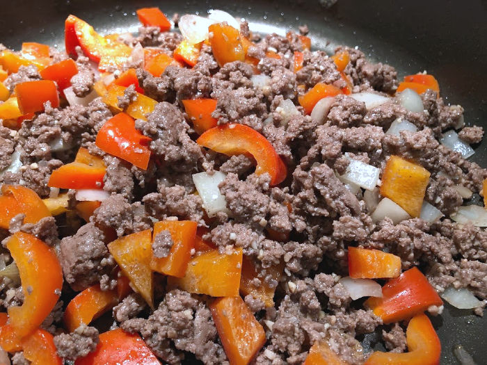 ground beef and peppers in a pan