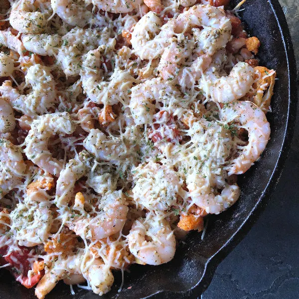 Winner, winner, Lenten dinner: Garlic Shrimp with Roasted Cauliflower, White Beans, and Tomatoes is a simple & delicious all-in-one cast iron skillet dinner recipe! Naturally gluten free (omit the optional baguette on the side or substitute GF bread of choice). | MashupMom.com skillet of garlic shrimp