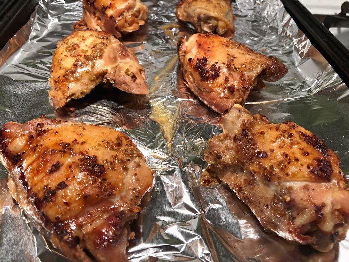 chicken thighs on a baking sheet