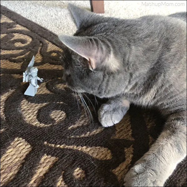 cat staring at a LEGO weeping angel