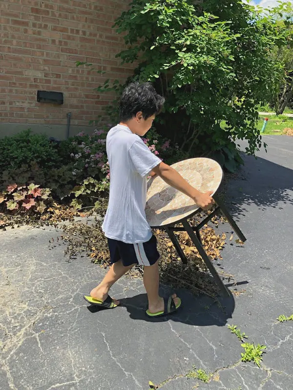 boy carrying a table