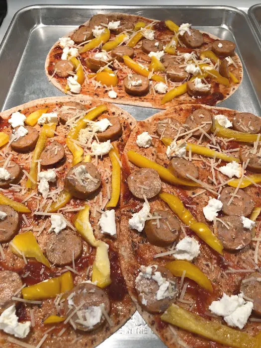 flatbread pizzas on a baking sheet