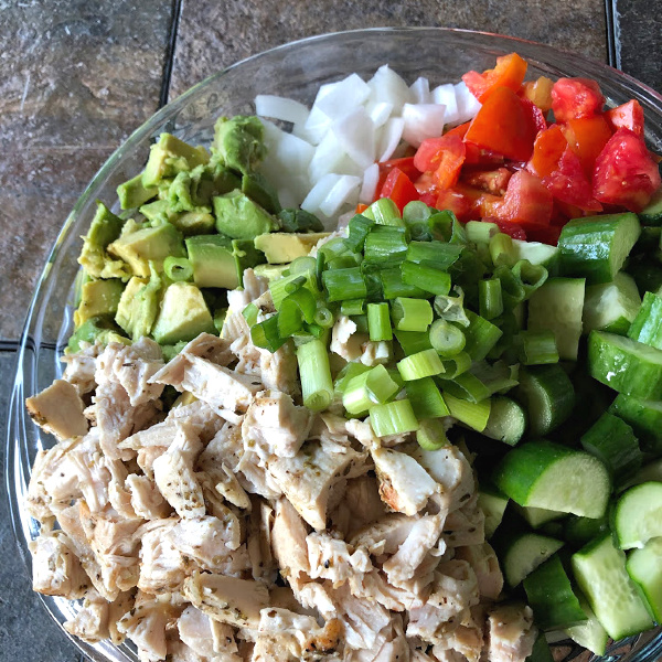 assembling the chopped chicken and veggie salad