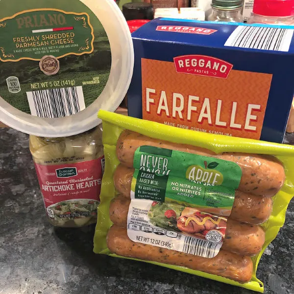 ALDI chicken sausage, parmesan cheese, artichoke hearts, and box of pasta
