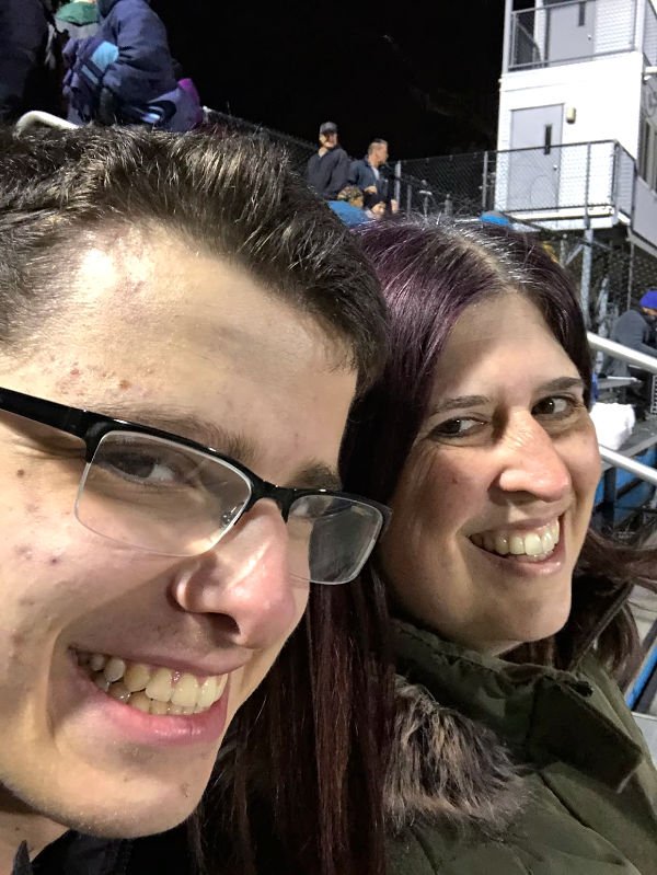 me and my high school kid sitting at a football game