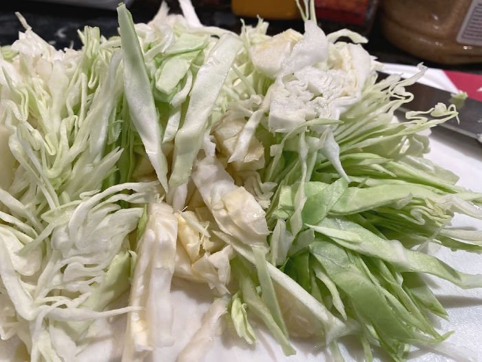 shredded cabbage on a cutting board