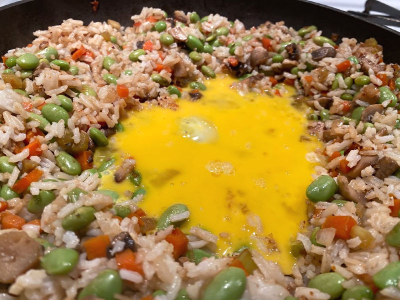 Make a well for egg in the middle of the fried rice.