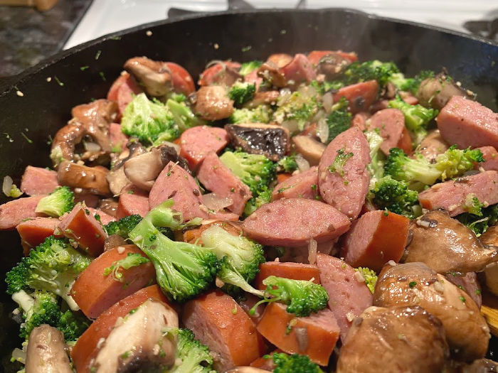 skillet of sausage broccoli and mushrooms