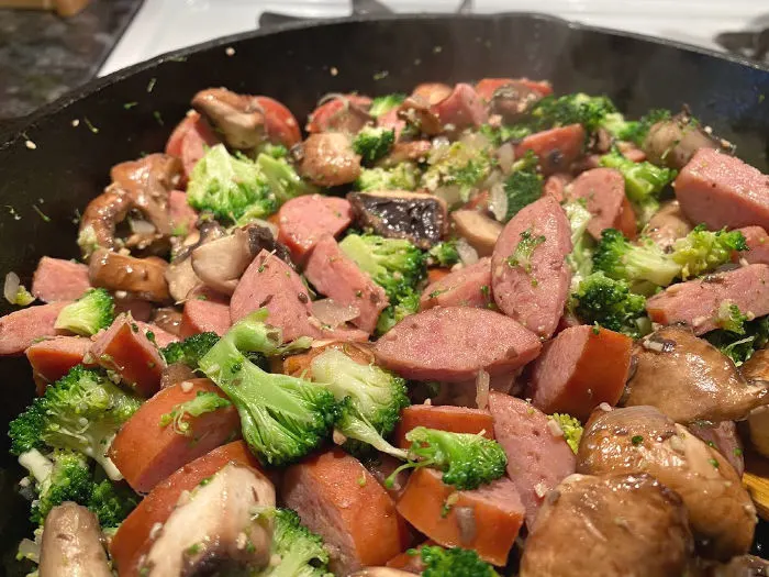 skillet of sausage broccoli and mushrooms