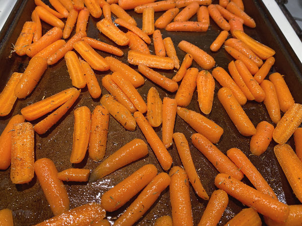 toss carrots with oil and spices on a baking sheet