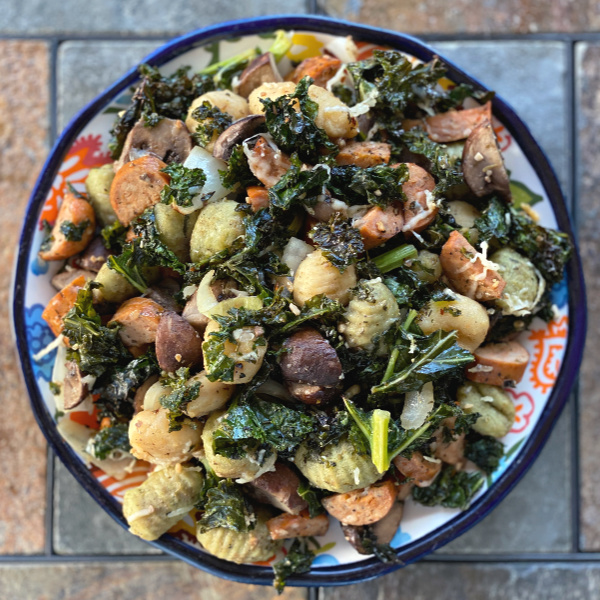 Plate of gnocchi with sausage and veggies