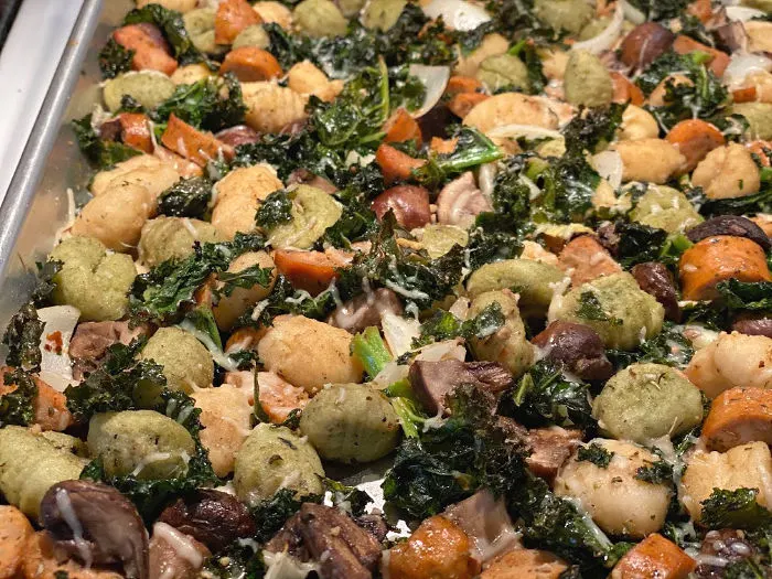 Sheet pan of roasted gnocchi with sausage kale and mushrooms
