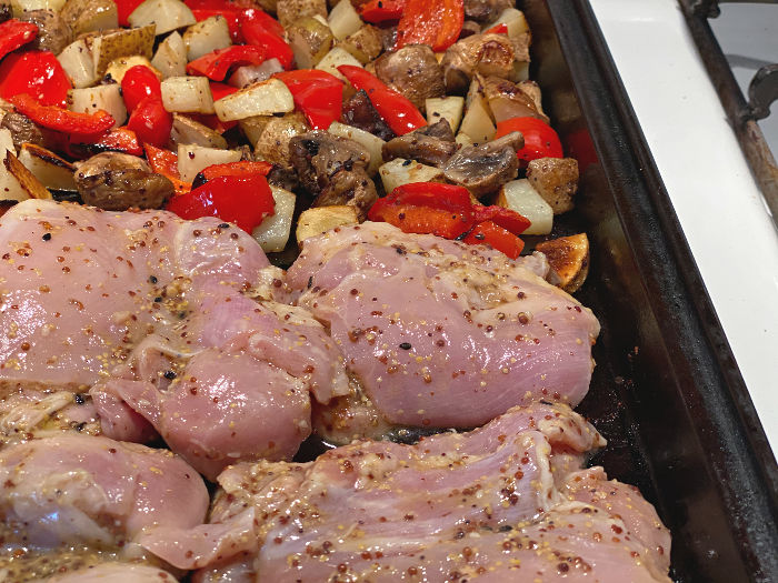 Add the marinated chicken to the pan with the vegetables