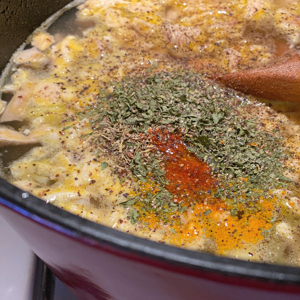 Add spices to the chicken soup and bring to a boil