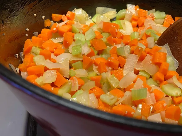 carrots, celery, onion, and garlic cooking up in a soup pot