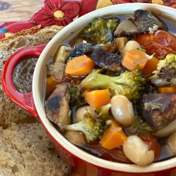 Bowl of chicken and roasted vegetable soup on a plate