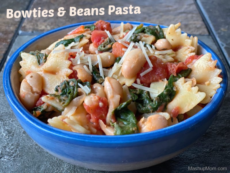 This 25 minute vegetarian Bowties & Beans Pasta recipe with white beans, spinach, and tomatoes comes together quickly on a busy weeknight, using mostly pantry staples! Flavorful & filling for your Meatless Monday. 