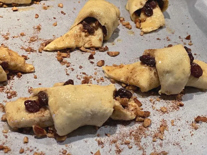 roll up rugelach and brush with butter