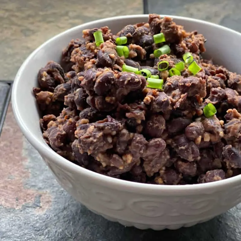 bowl of slightly smashed black beans