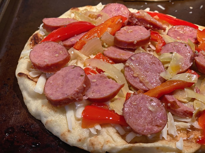 add sausage and cheese on the naan pizza
